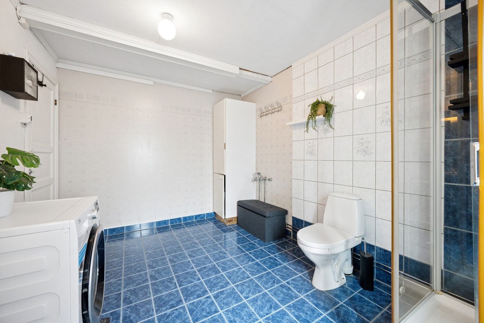 Badet er fra 1990-tallet og har opplegg for vaskemaskin. Galleribilde