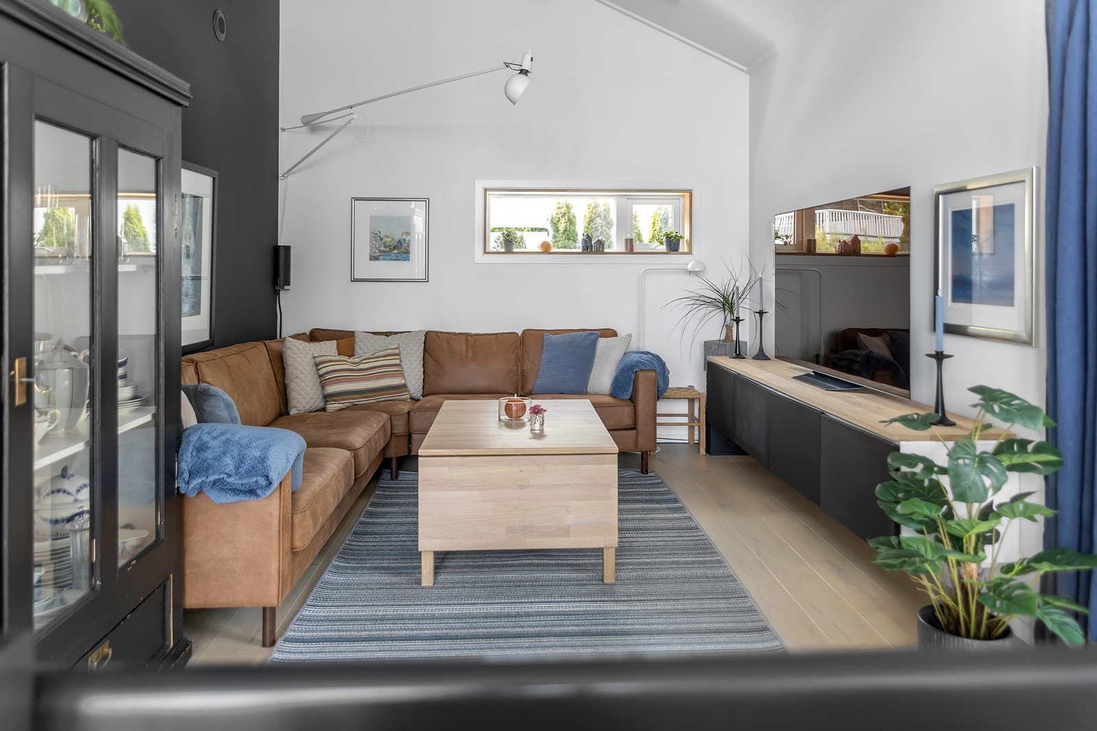 Hyggelig stuedel med god takhøyde, lyse overflater og utgang til overbygd terrasse-/uteplass. Galleribilde