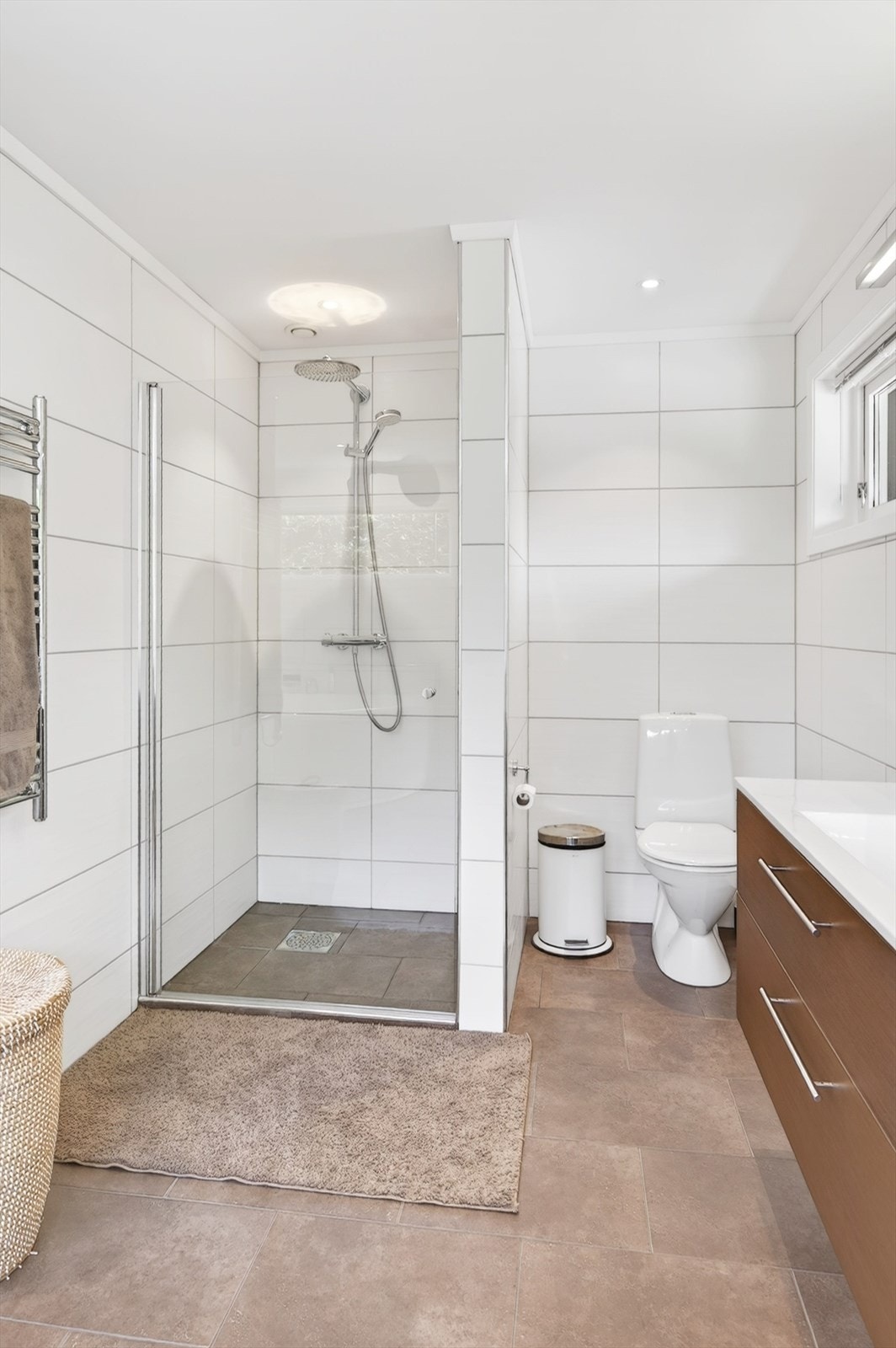 I tillegg til badekar har badet et separat dusjhjørne med glassdører. Galleribilde
