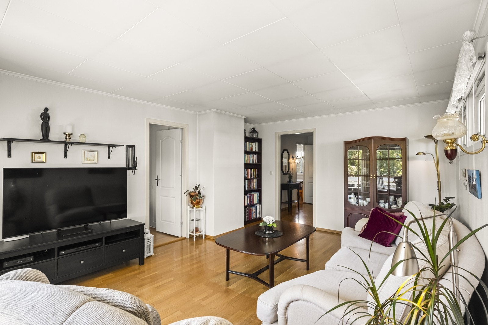 Stuen har parkett på gulvet og utgang til verandaen som vender mot grønne fellesarealer. Galleribilde