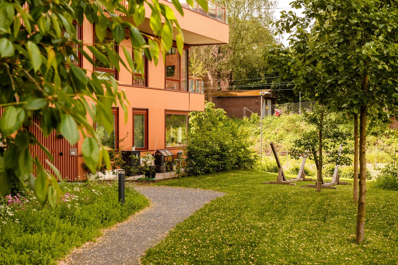 Pent opparbeidet uteområde med gangstier og beplantning. Galleribilde