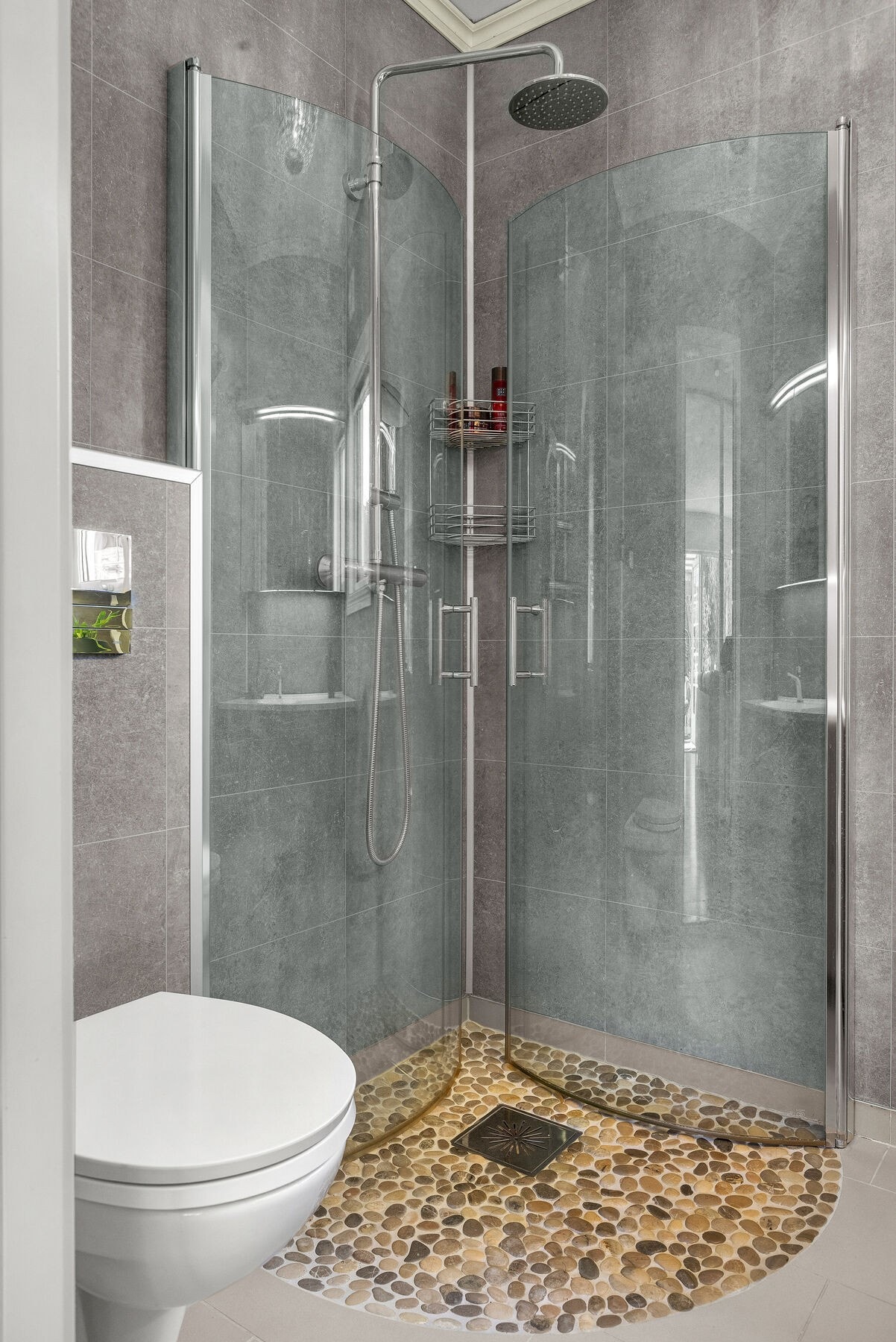 Rommet har dusjhjørne, veggmontert toalett og fuktstyrt elektrisk vifte. Galleribilde