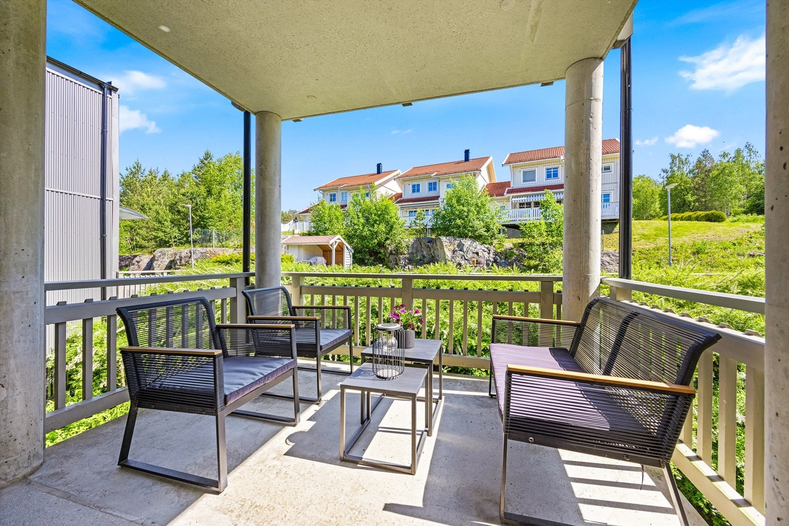 Utenfor inngangsdøren er det en overbygd svalgang med plass til en liten sittegruppe. (dette er fellesområde for beboerne men til nå har eiere av denne leiligheten benyttet plassen. Her får du morgensol. Galleribilde