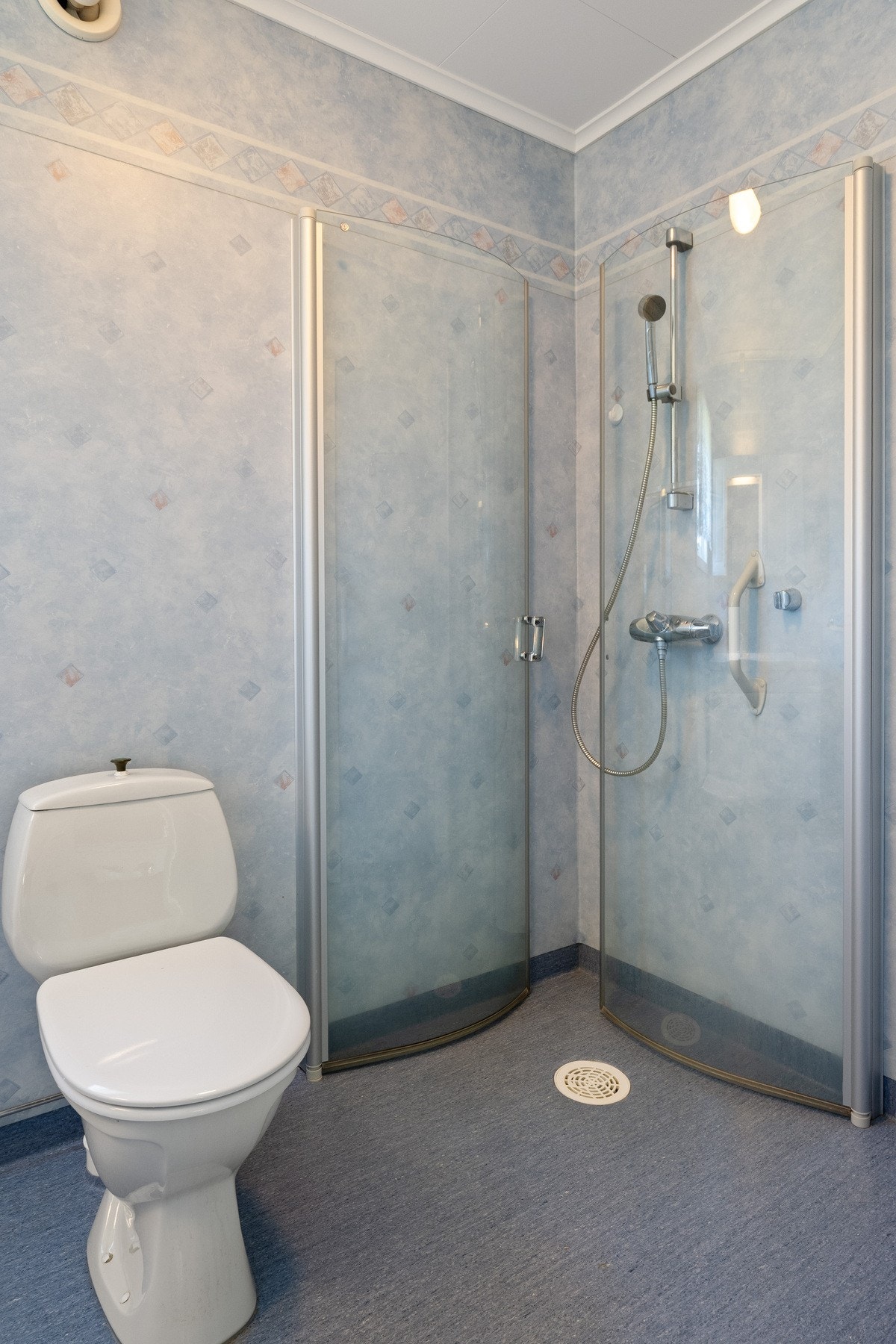 Badet er innredet med sevantinnredning, dusjhjørne og toalett. Galleribilde