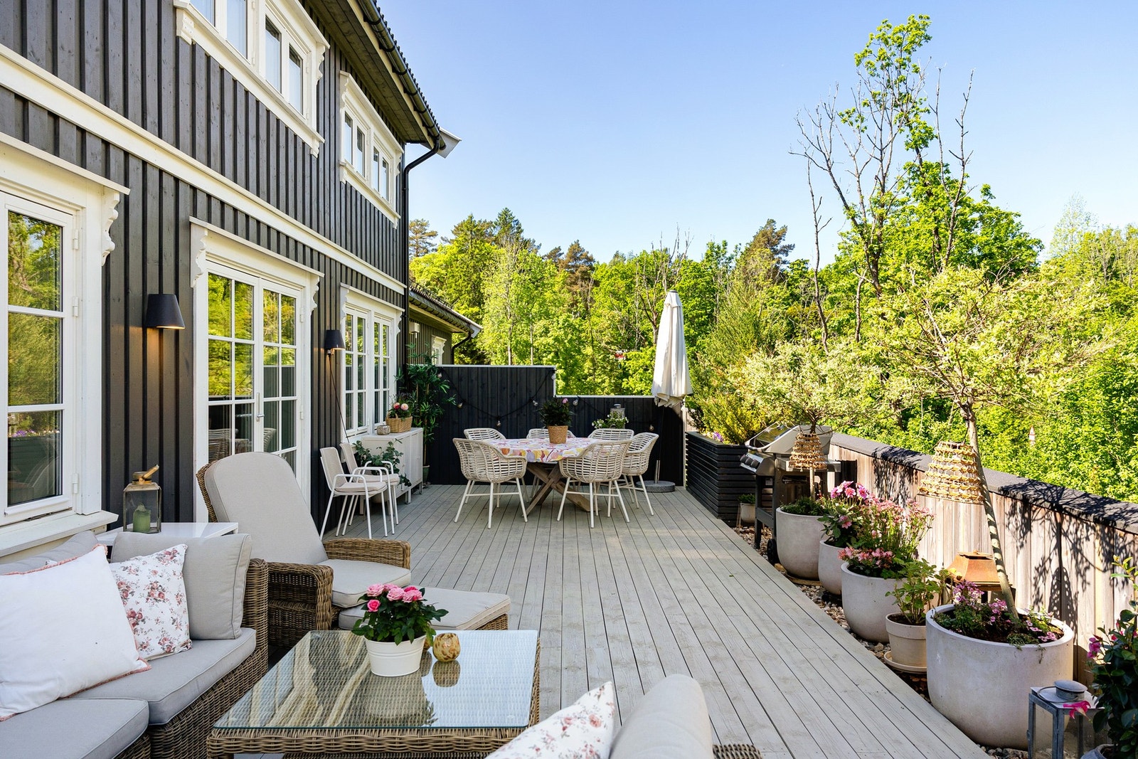 En imponerende terrasse med rikelig plass til både spisebord, grill og komfortable sittegrupper - et naturlig samlingspunkt gjennom sommerhalvåret. Galleribilde