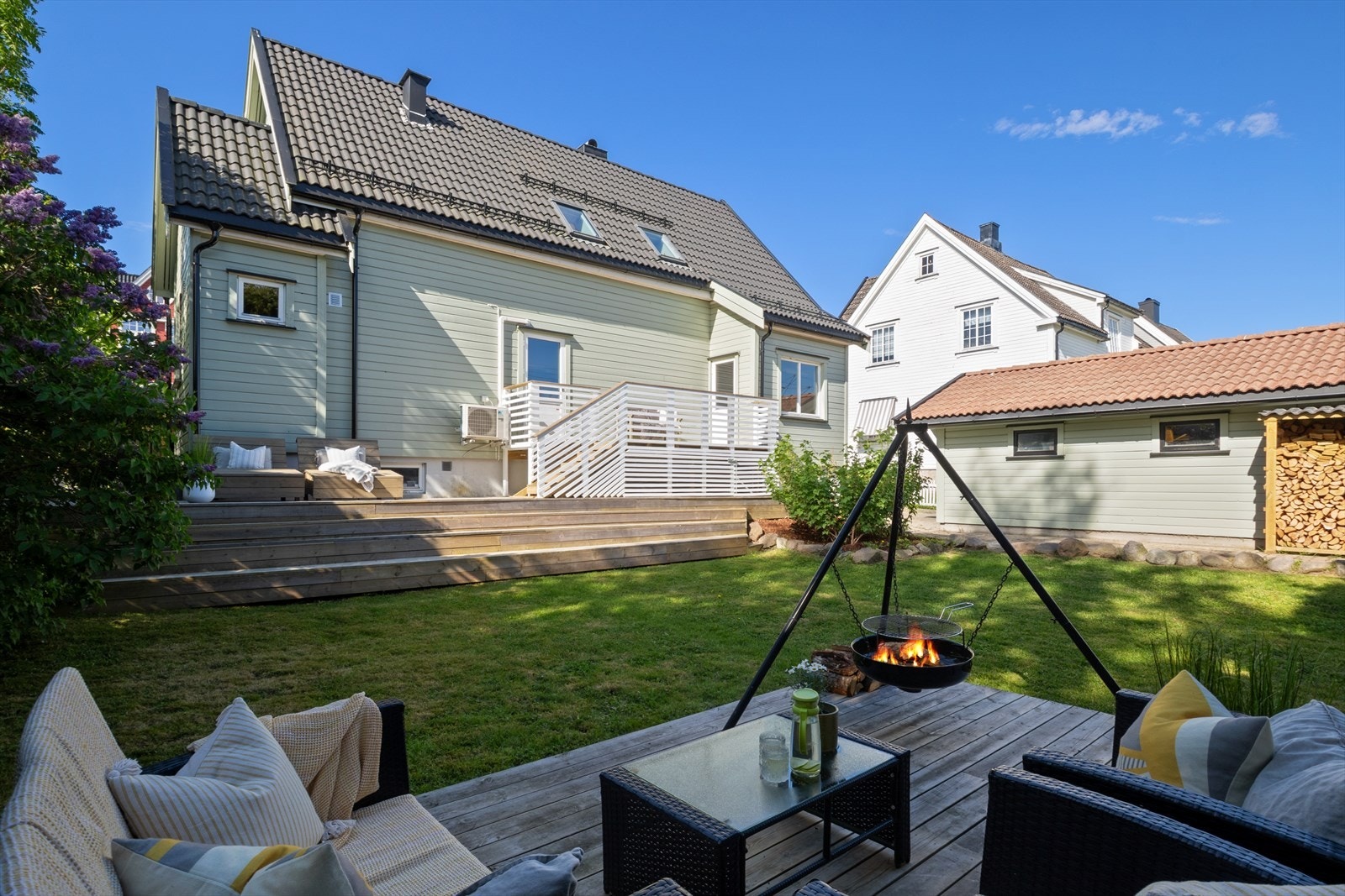Eiendommen har flere nivåer med terrasser og plen, som gir varierte soner for lek og avslapning. Galleribilde