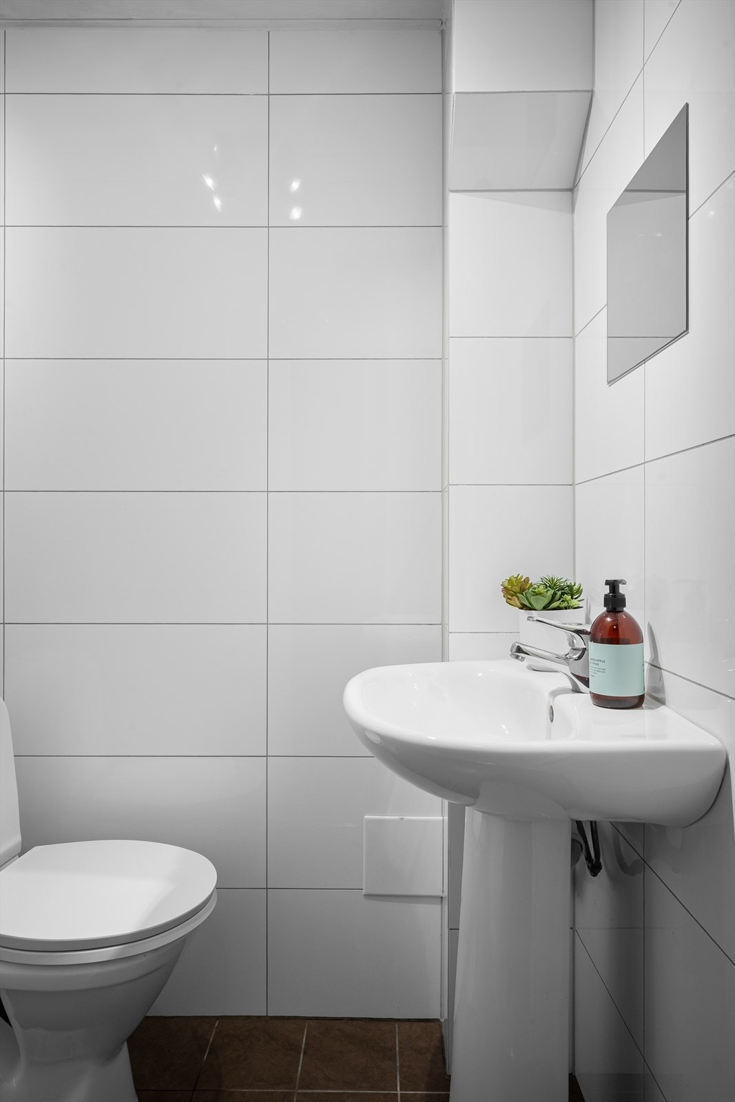 Bad i underetasje har fliser på gulv og vegg, og er innredet med toalett, servant og dusj. Galleribilde