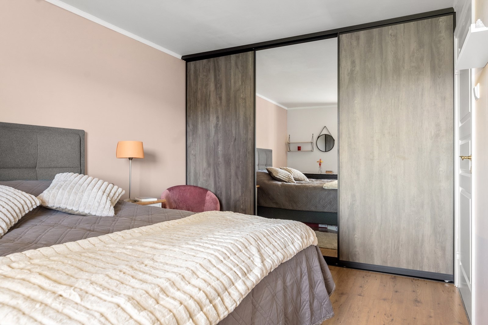 En romslig skyvedørsgarderobe med speilfront gir rikelig med oppbevaringsplass. Galleribilde