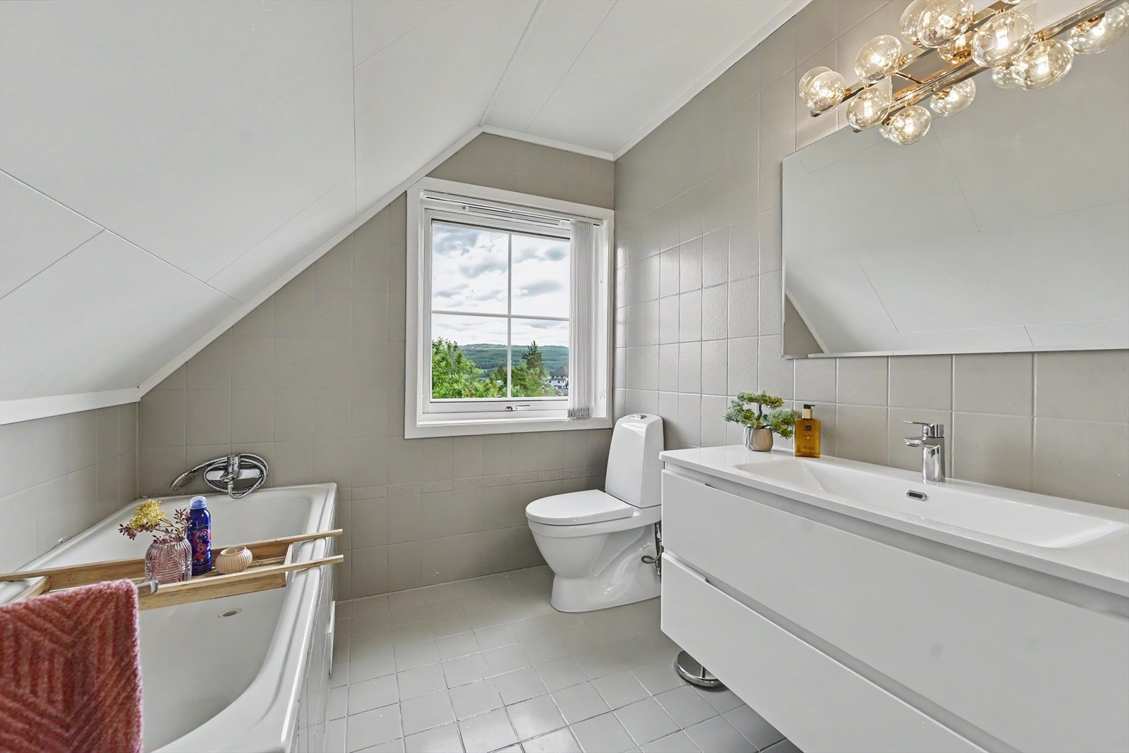 Badet i andre etasje er innredet med badekar, toalett og et stort servantmøbel. Galleribilde