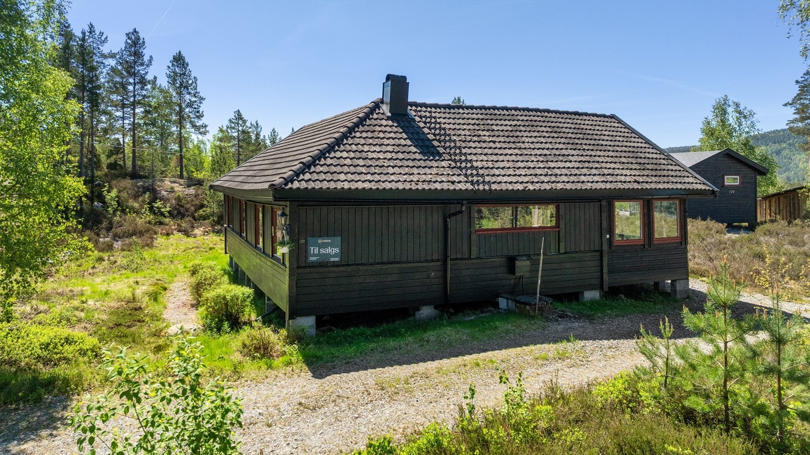 Det er parkering rett ved hyttevegg Galleribilde