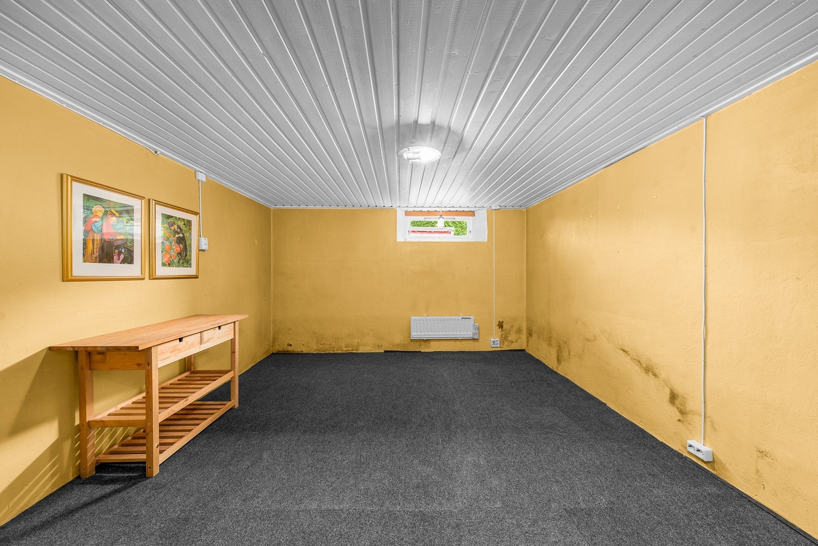 Rommet har teppegulv og panel i taket. Galleribilde