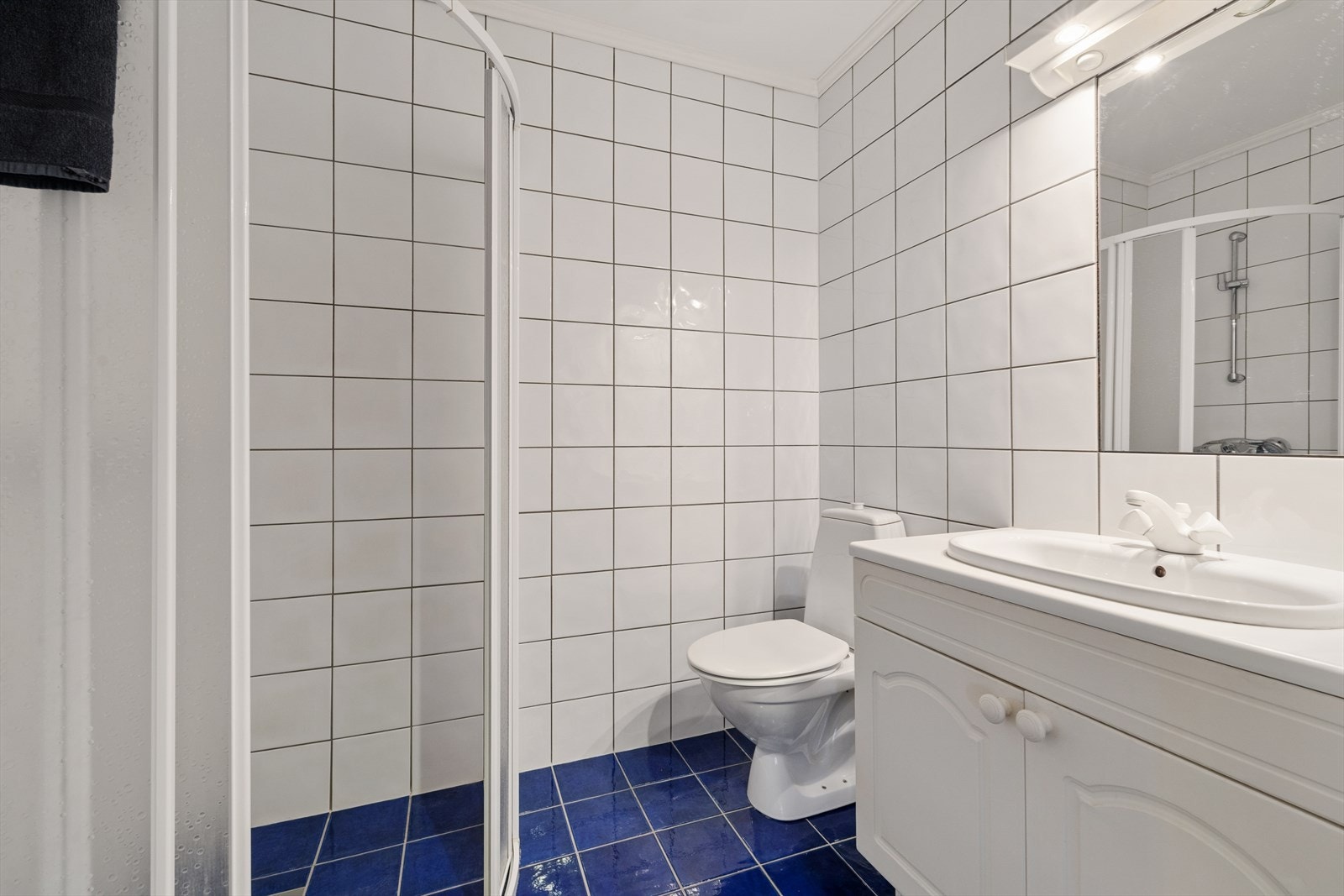 Badet i hoveddelen har flislagte overflater og dusjhjørne. Galleribilde