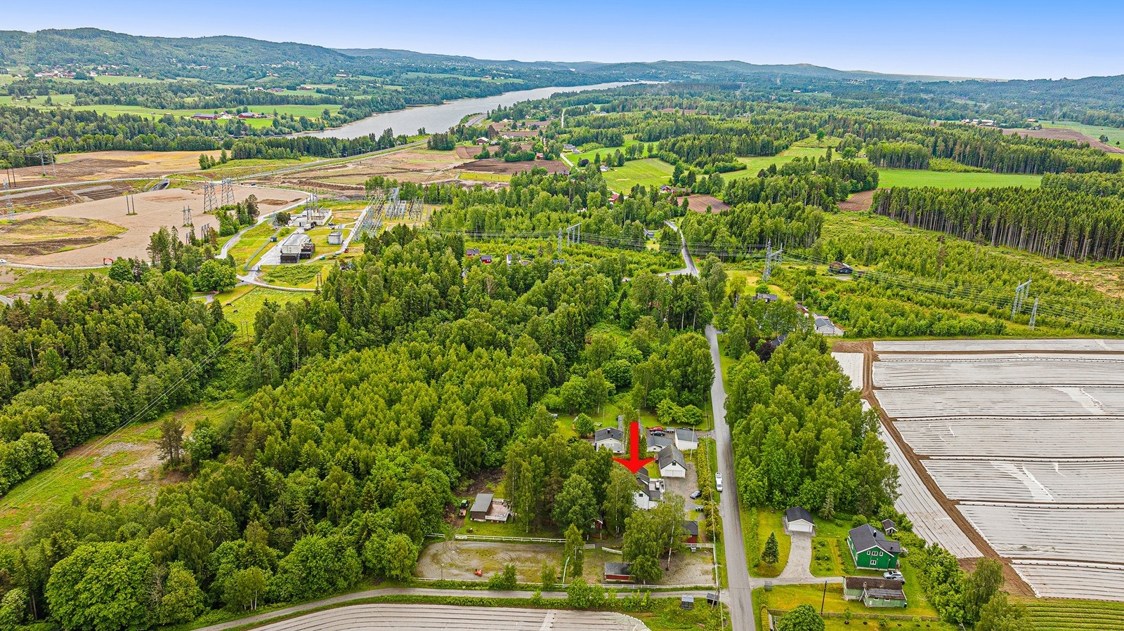 Fra eiendommen er det utsikt mot kulturlandskap og Mjøsa i det fjerne. Galleribilde