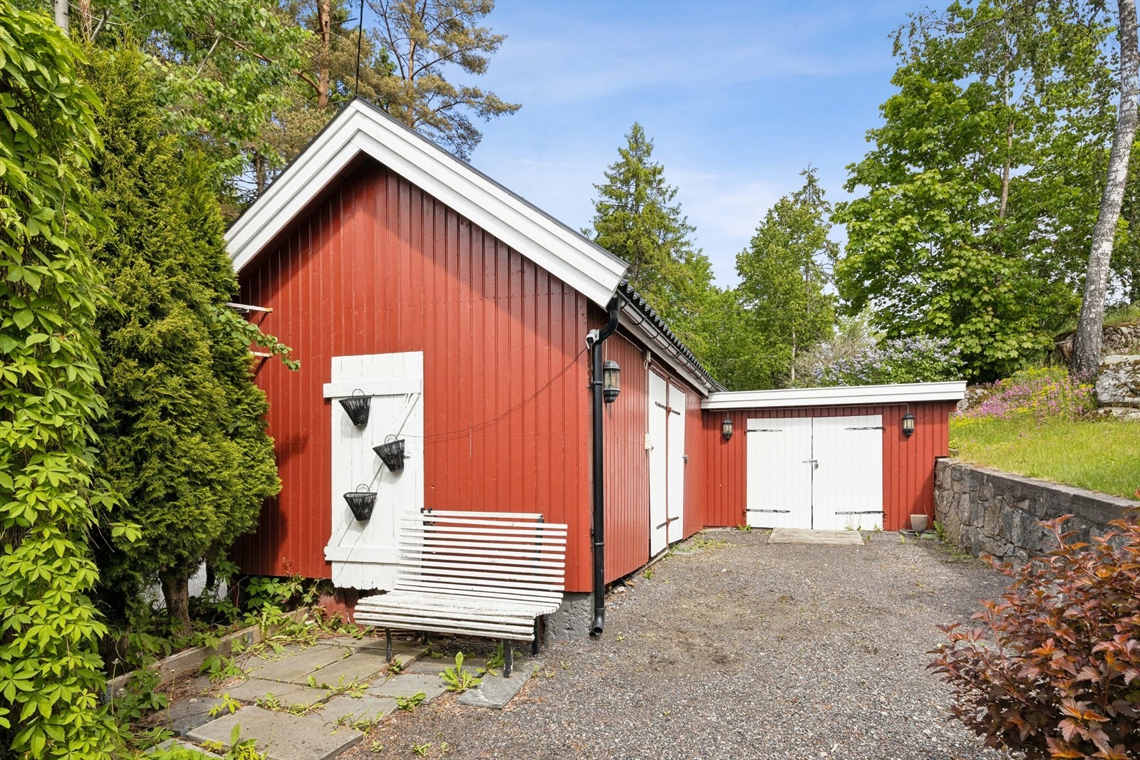 Vedskjulet fra 1927 har låsbare porter og er praktisk for oppbevaring. Galleribilde
