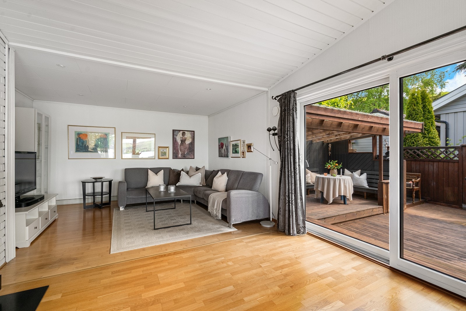 Fra stuen er det utgang til en skjermet og delvis overbygd terrasse, hvor man kan nyte fine dager utendørs i lune og trivelige omgivelser. Galleribilde