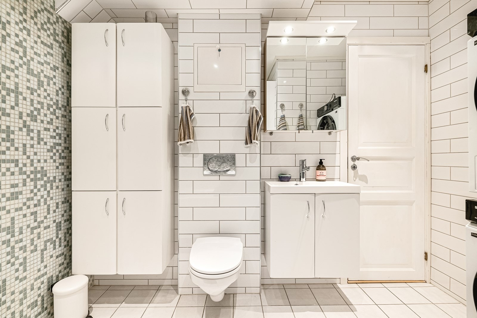 Badet er innredet med vegghengt toalett, servant, badekar og godt med skapplass. Galleribilde