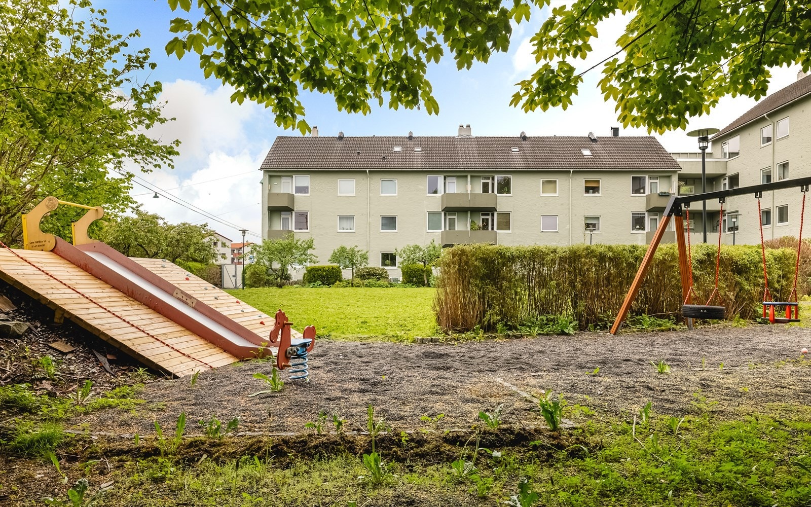 Fellesområdene er pent opparbeidet med plen, beplantning og lekeapparater. Galleribilde