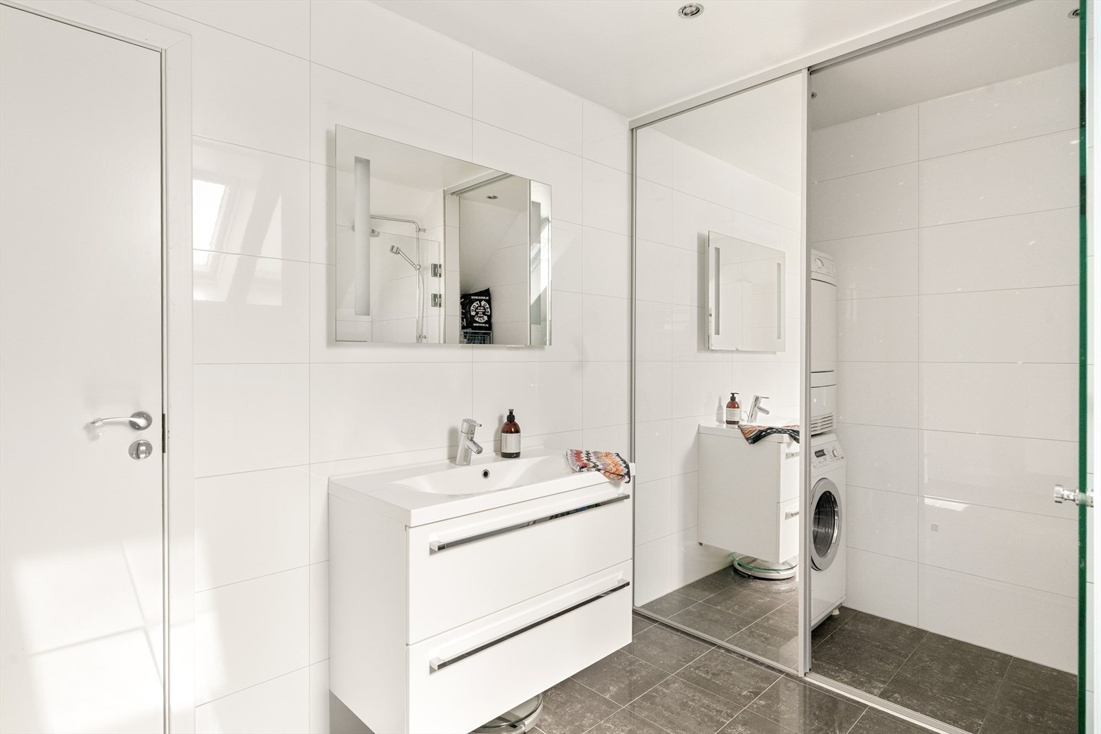 Badet er innredet med servant, vegghengt toalett og dusjløsning. Galleribilde
