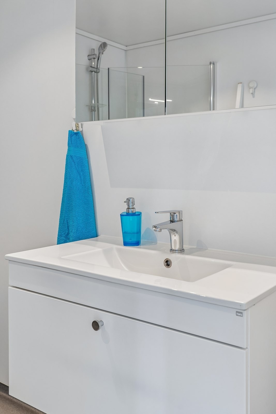 Badet er utstyrt med opplegg for vaskemaskin, innfellbare dusjvegger, vegghengt toalett og gulvvarme Galleribilde