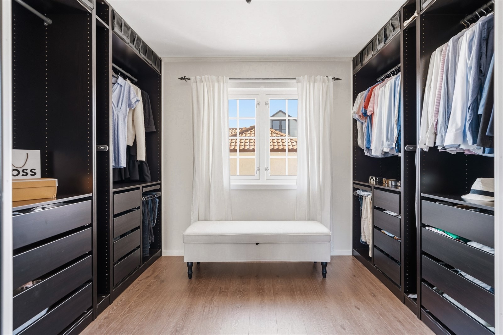 Romslig walk-in closet med rikelig oppbevaringsplass og praktiske innredningsløsninger. Galleribilde