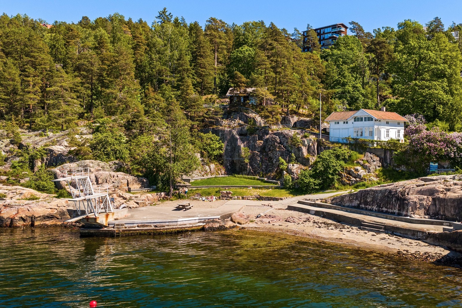 Den lokale badeplassen har sandstrand, steinbrygger og et ikonisk stupetårn. Galleribilde
