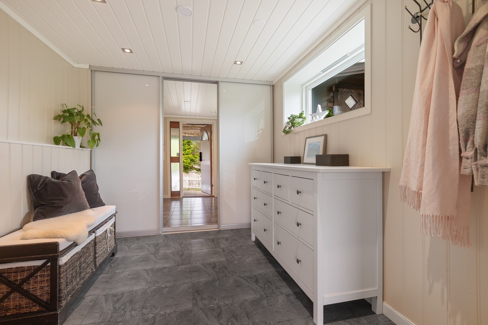 Romslig entré/hall med garderobeløsning og god plass til å ta imot gjester. Denne delen av boligen er del av påbygget gjort i 1996 Galleribilde