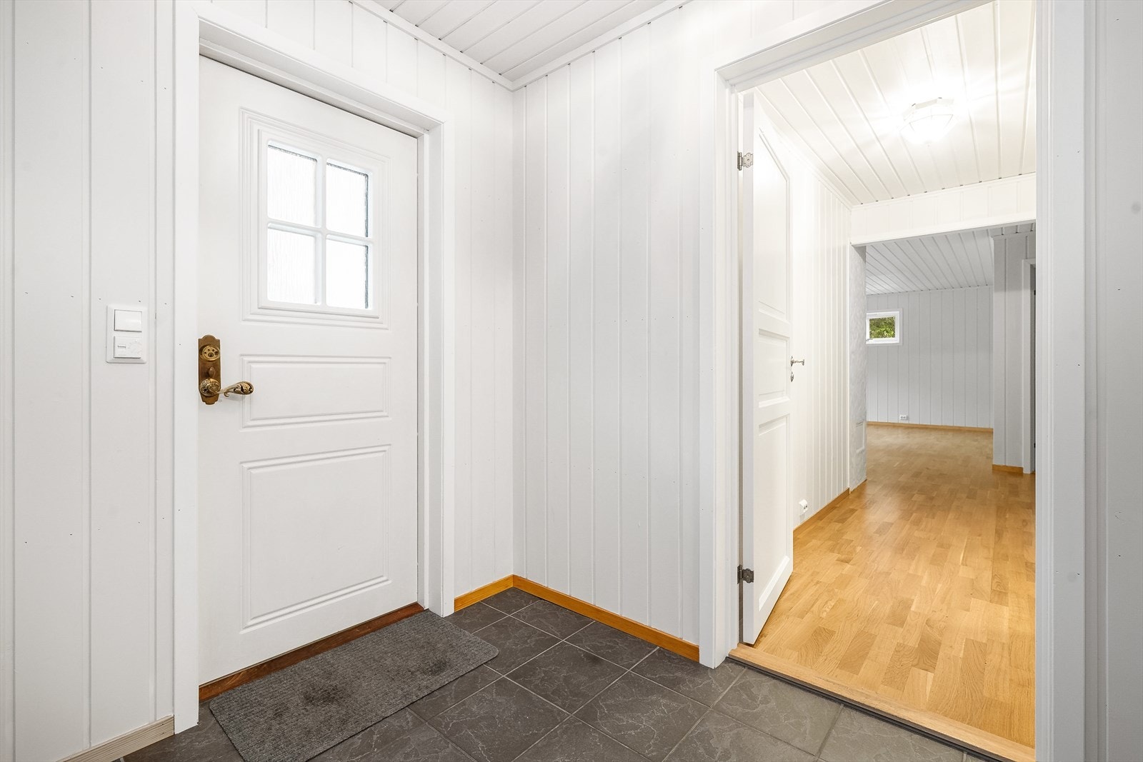 Vindfang med flislagt gulv og panelkledde vegger. Galleribilde