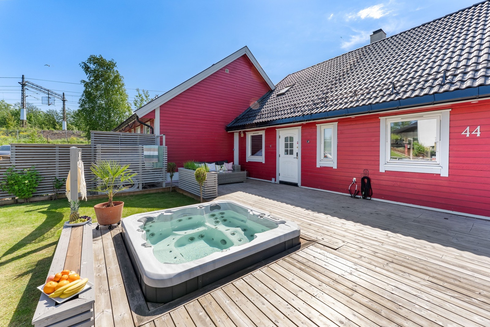 Jacuzzien er plassert som et naturlig samlingspunkt på terrassen og bidrar til en eksklusiv uteopplevelse. Galleribilde