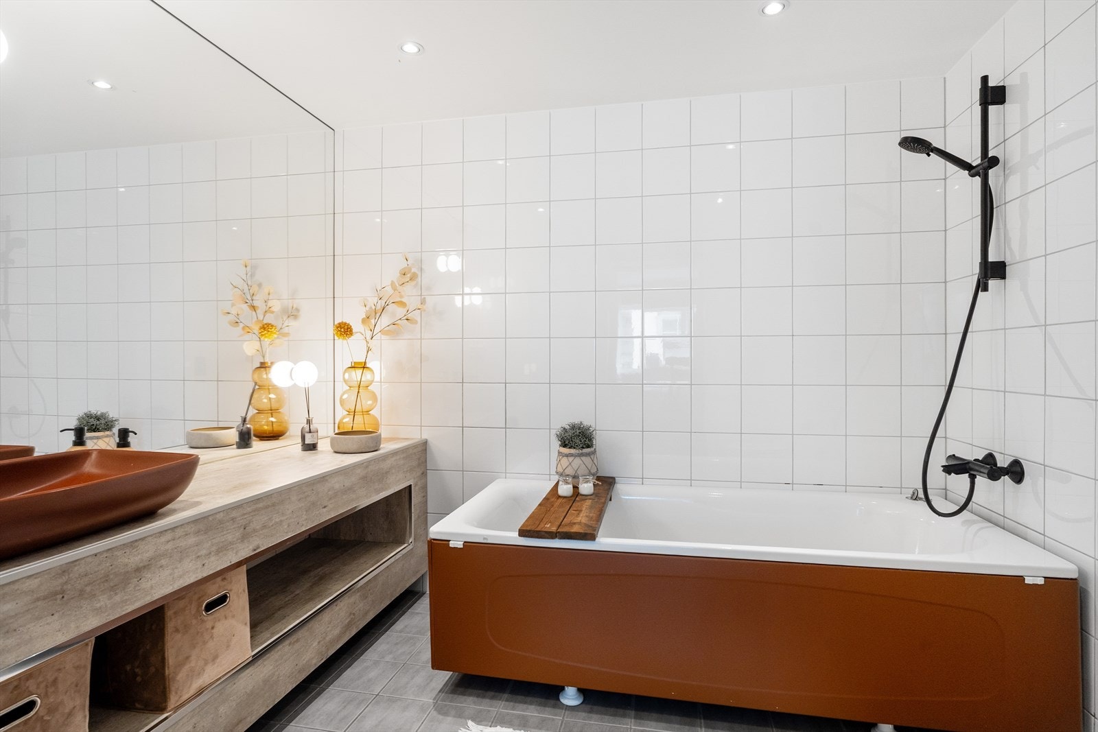 Badet inneholder badekar, innredning med servant og vegghengt toalett Galleribilde