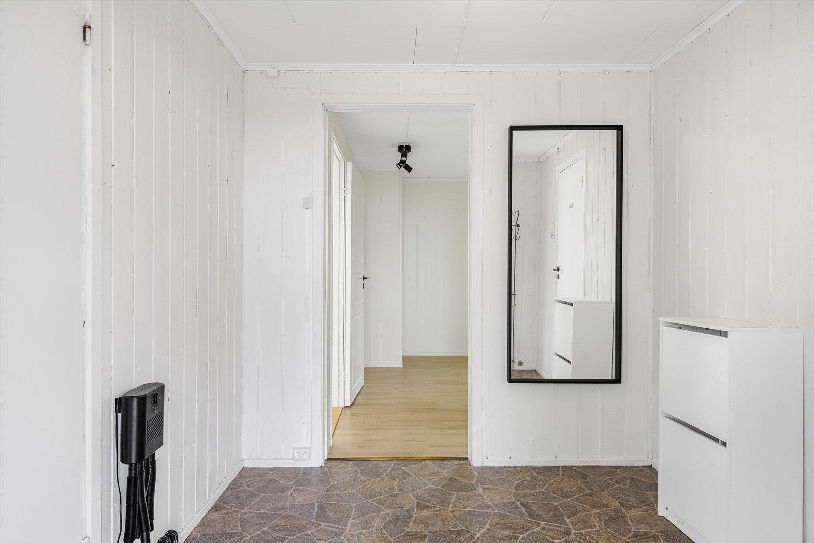 Du ønskes velkommen inn i en lys og romslig entre med plass til garderobeskap. Montert skotørker på vegg. Galleribilde