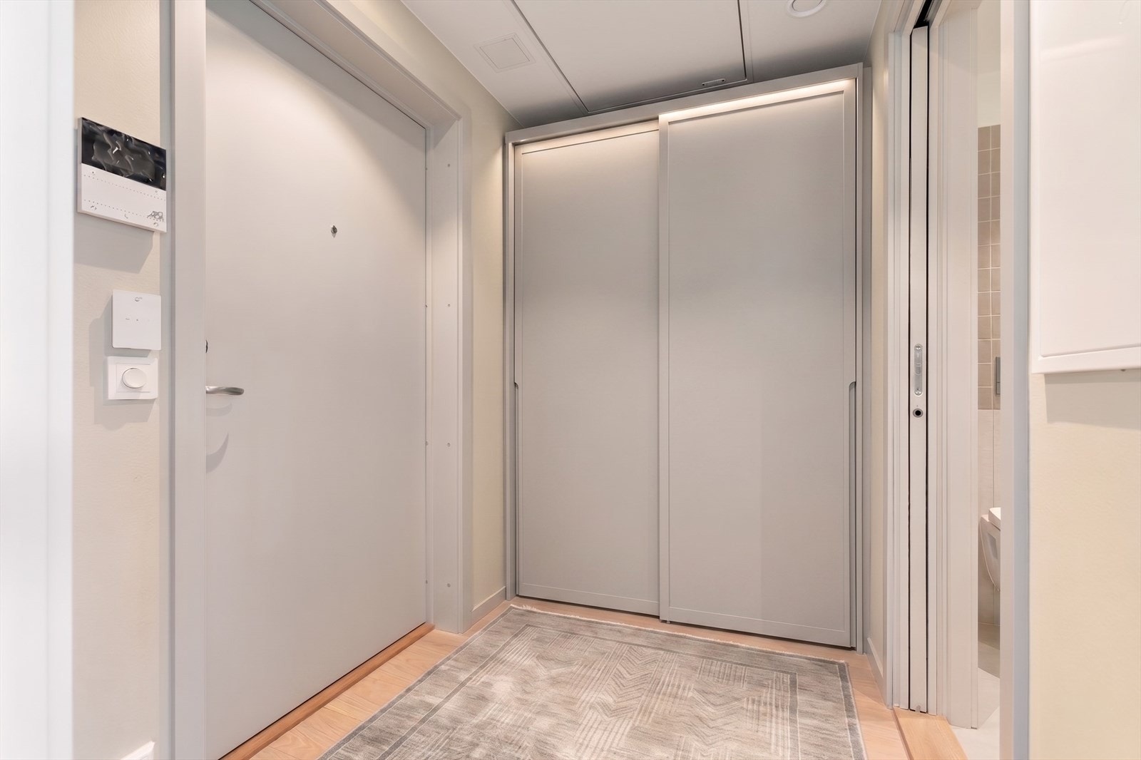 Fin entré m. plass til garderobe, klær og sko. Porttelefon. Foto er redigert digitalt/med KI og er kun til illustrasjon. Avvik vil forekomme. Skyvedørsgarderobe medfølger ikke. Galleribilde