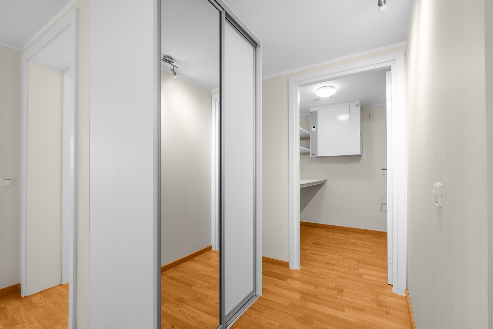 Romslig gang med praktisk skyvedørsgarderobe med speilfront Galleribilde