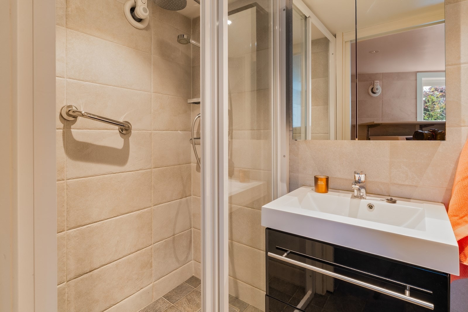 Badet ble renovert i 2014 og holder en praktisk standard. Flislagte overflater kombinert med varmekabler i gulvet skaper en behagelig komfort året rundt, mens downlights i taket gir et stilrent uttrykk. Galleribilde