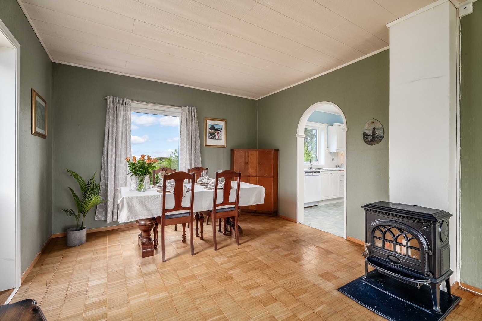 Lun og god vedovn i stue, legg også merke til det karakteristiske gulvet som matcher husets stil. Galleribilde