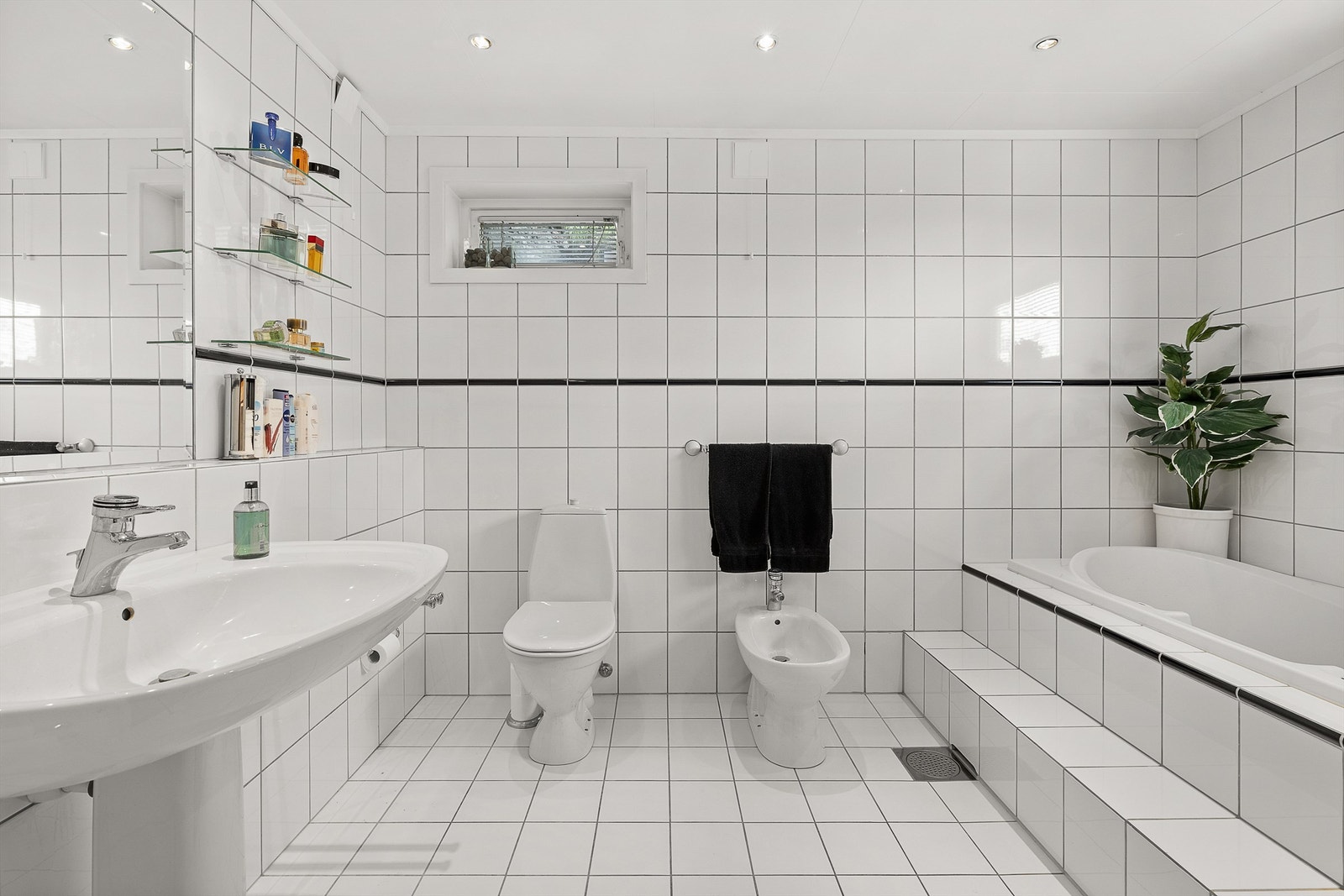 Bad 2 av 4: Et romslig og flislagt bad med gulvvarme og downlights i himling Galleribilde