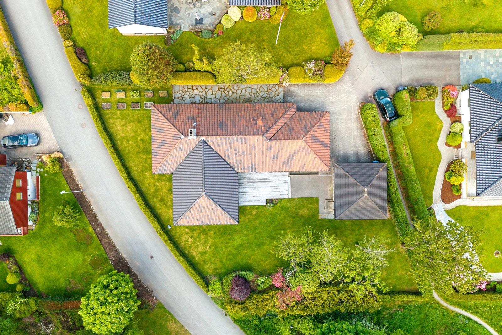 Den lave bygningskroppen, de store vindusflatene og den gjennomtenkte plasseringen på tomten skaper en naturlig sammenheng mellom bolig og hage. Galleribilde