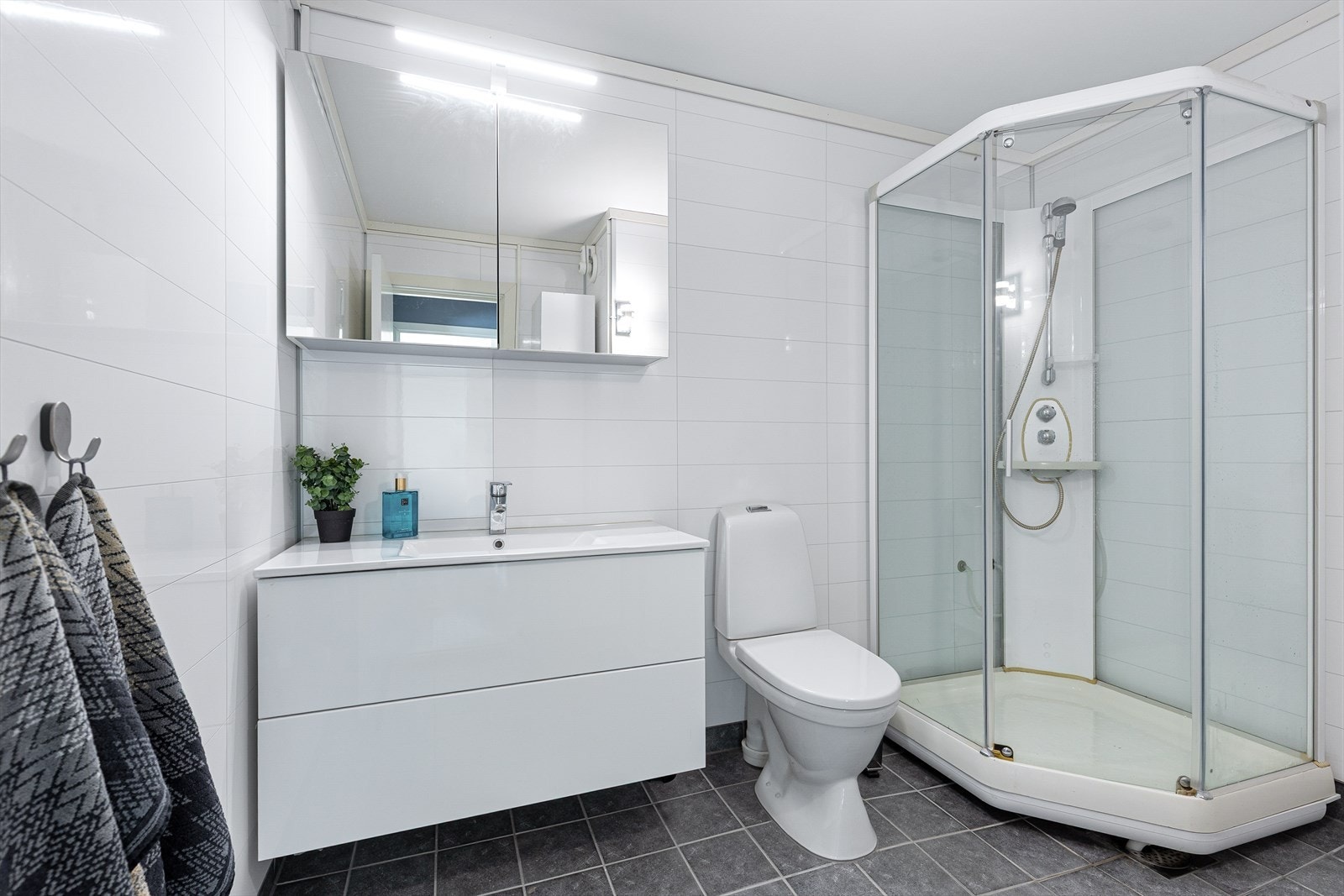 Badet innehar standard fra ca. 2000, men ble oppgradert med våtromsplater på vegger og nye fliser over eksisterende på gulv i 2020. Galleribilde