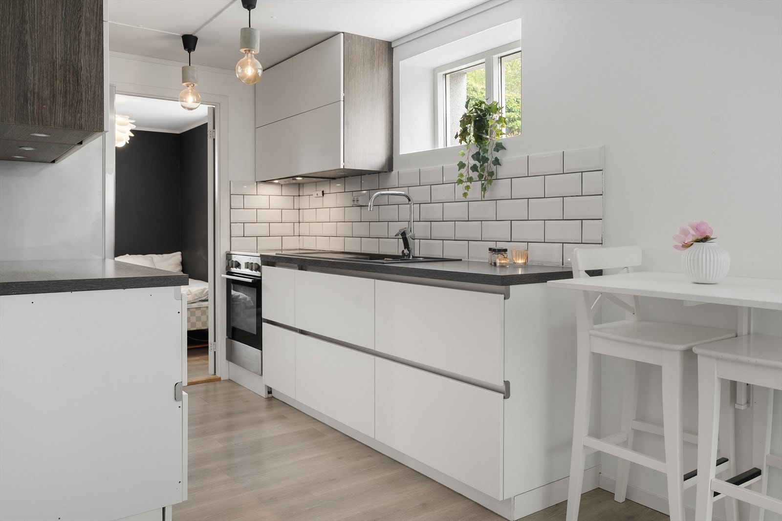 Kjøkkeninnredning fra 2018 med glatte fronter og benkeplate i laminat. Det er integrert oppvaskmaskin. Galleribilde