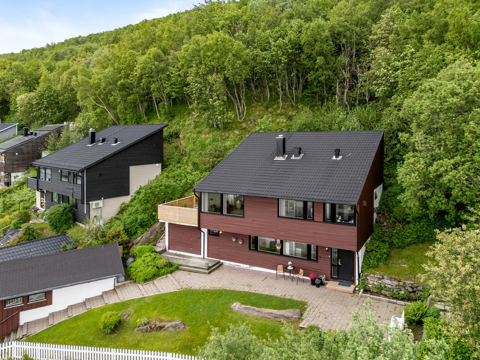 Boligen ligger fint til i terrenget, med grøntområder som nærmeste nabo. Galleribilde