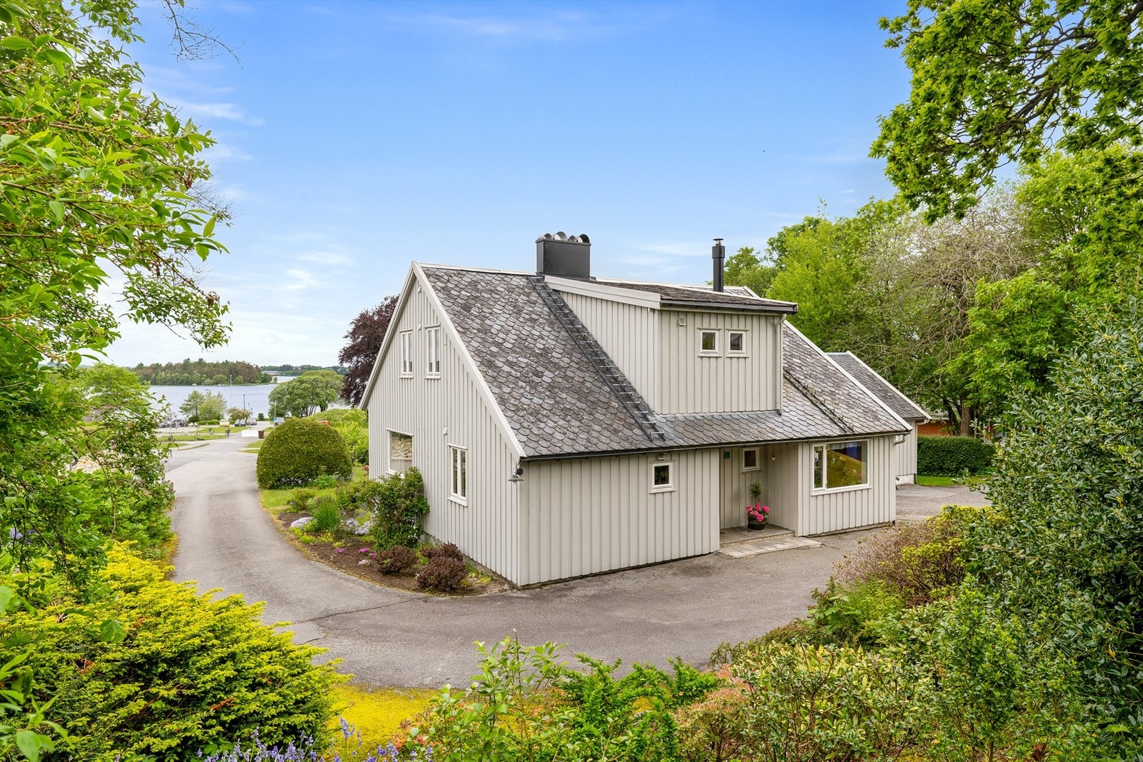 Eiendommen ligger fint til i terrenget med utsikt mot vannet. Galleribilde
