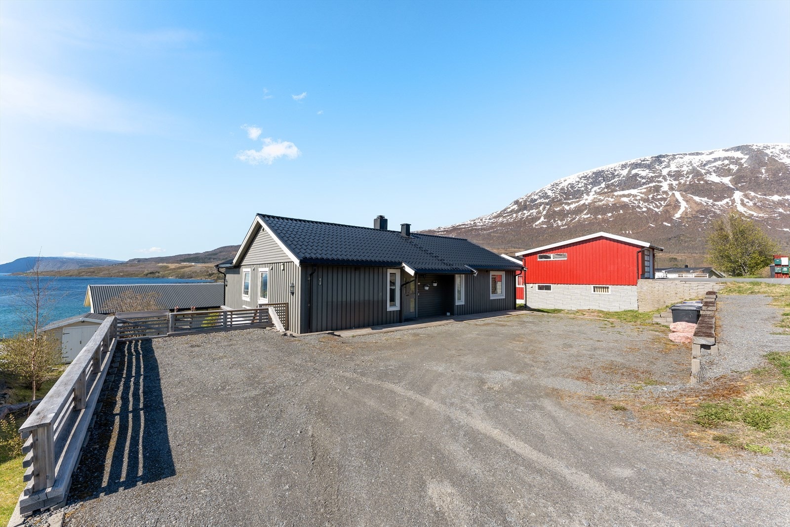 Tomten er opparbeidet med en stor parkeringsplass. Galleribilde