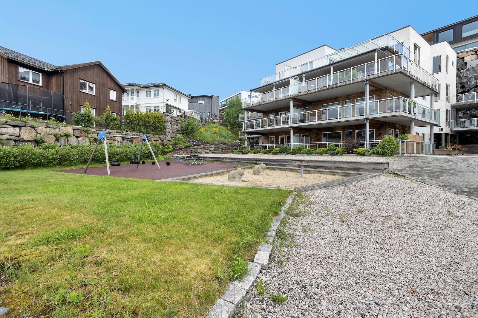 Fellesområdet med lekeplass og nedgravde søppeldunker. Galleribilde