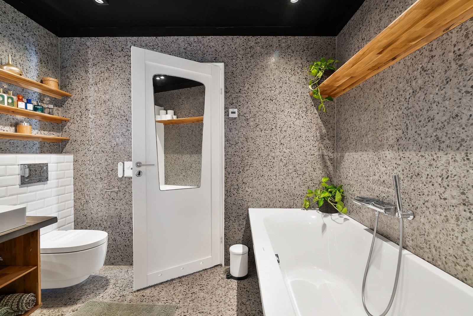 Badet er innredet med både badekar og vegghengt toalett. Galleribilde