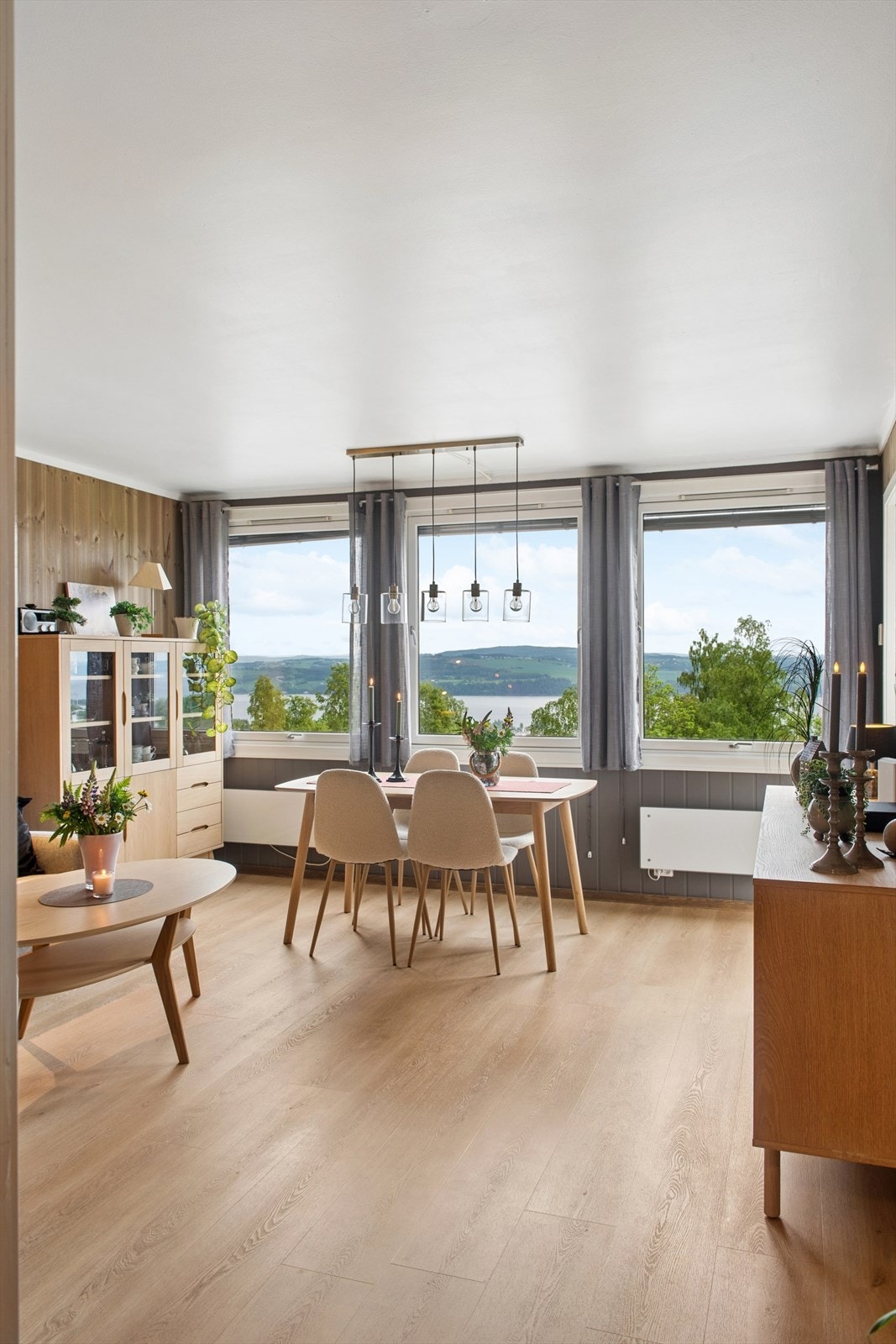 Stuen har laminatgulv og panel på veggene, begge deler lagt i 2024. Rommet har plass til både spisebord og sofagruppe. Galleribilde