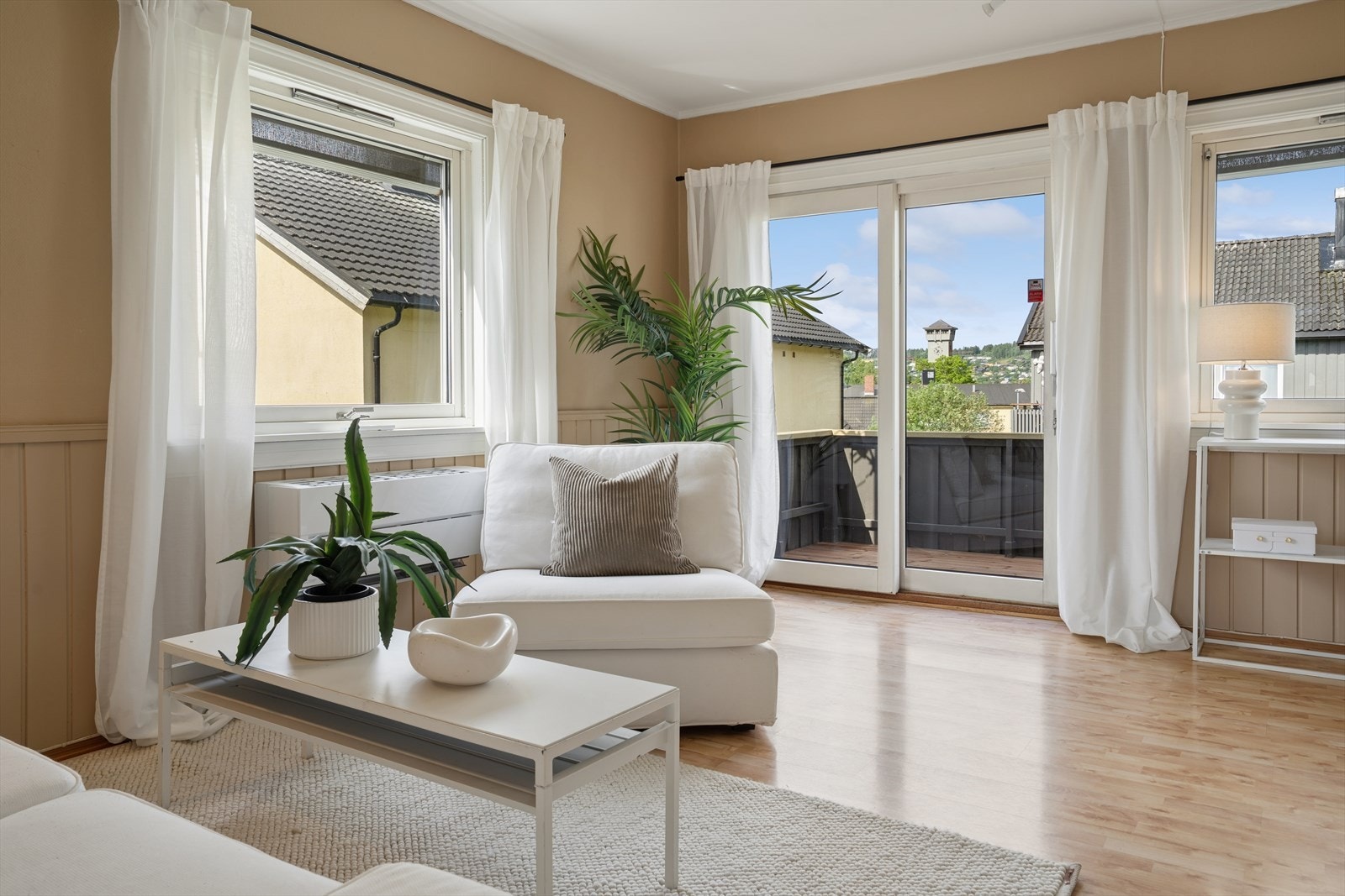 Balkongdør og vinduer slipper inn rikelig med lys og kobler stuen til uteområdet. Galleribilde