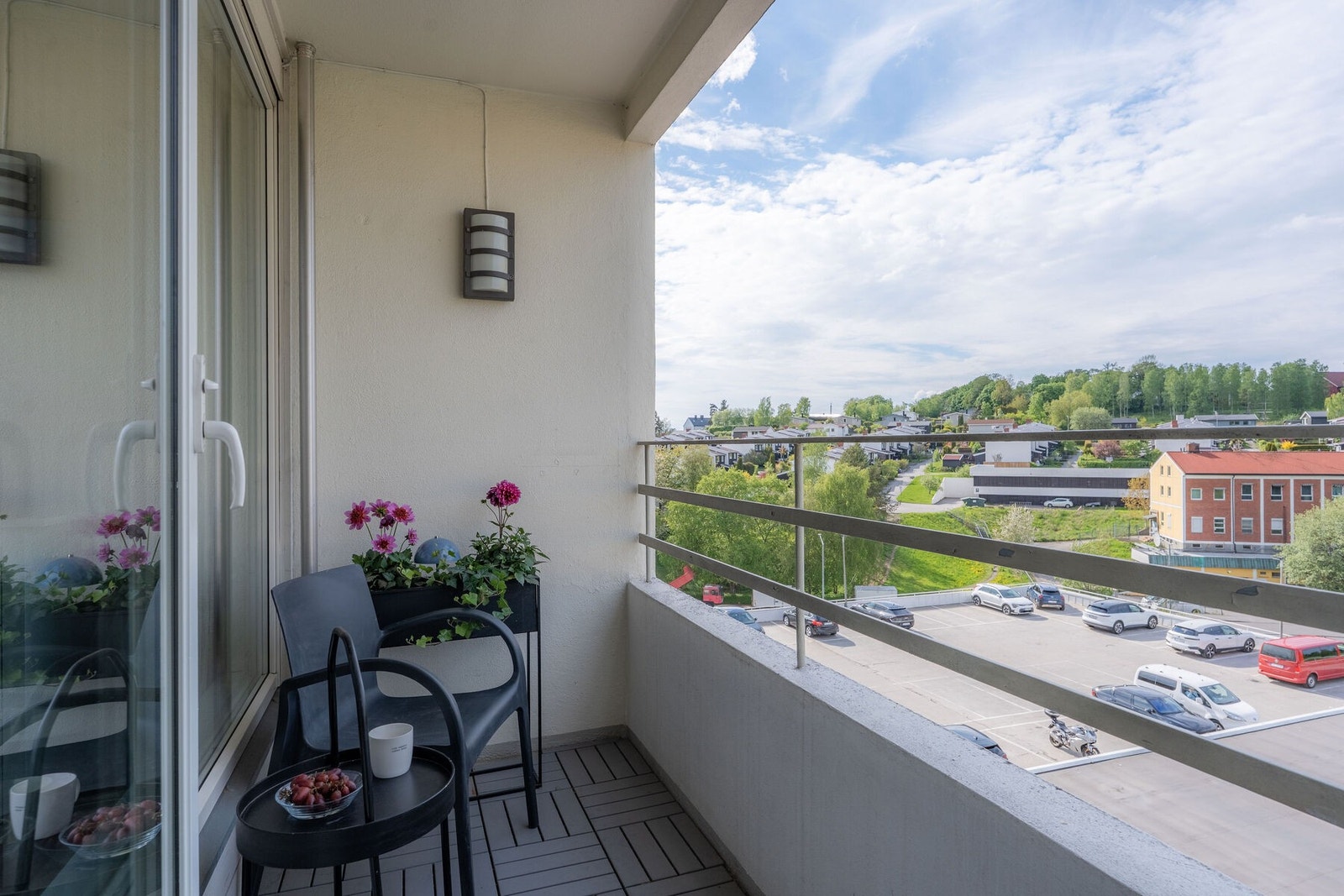Fra stuen er det utgang til en hyggelig balkong vendt mot rolige omgivelser og grønne trær, en perfekt plass for morgenkaffen eller avslappende sommerkvelder Galleribilde