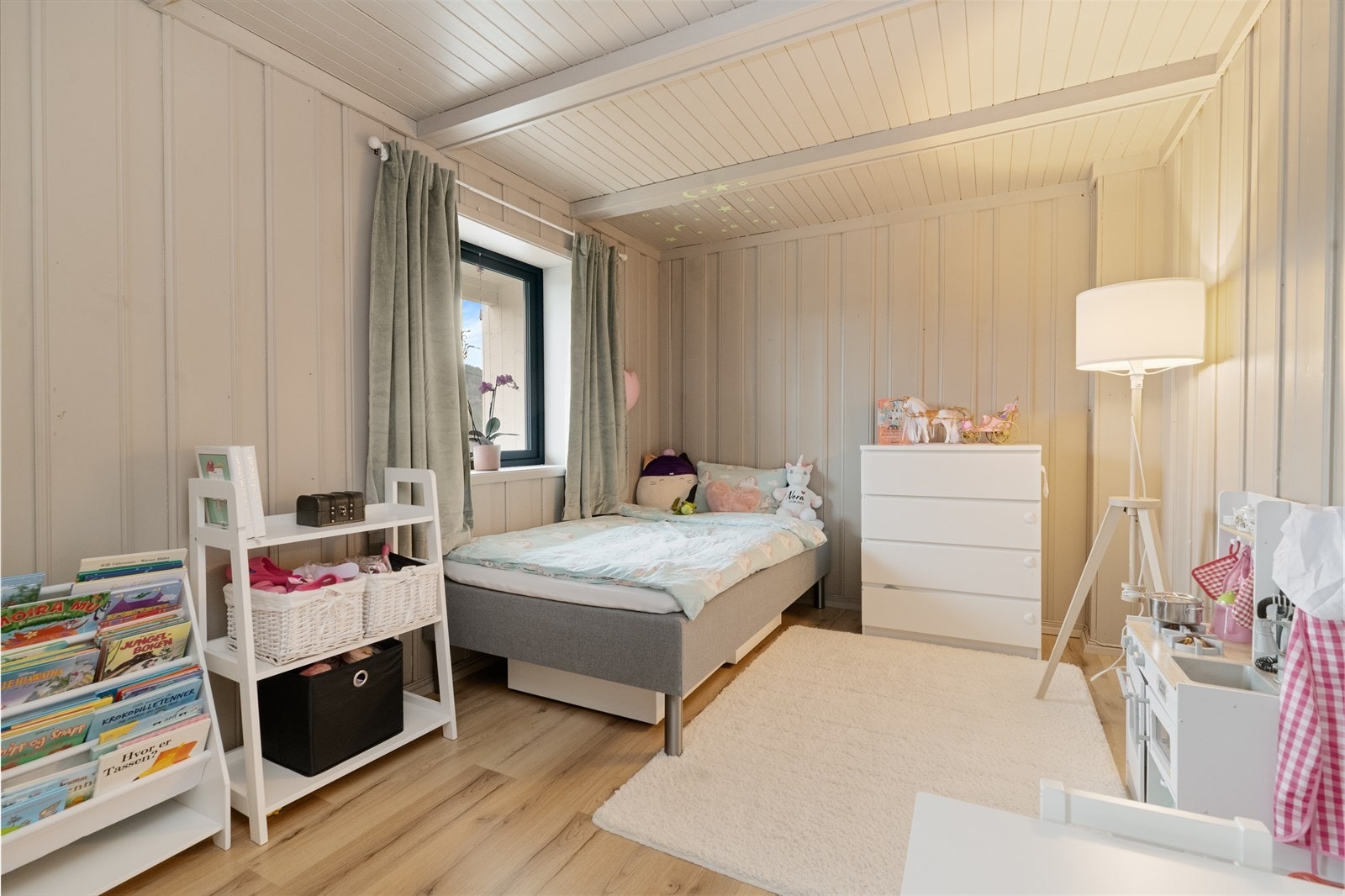Ett av to soverom i sokkeletasjen. Rommet har malt panel på vegger og tak, og laminat på gulvet. Galleribilde