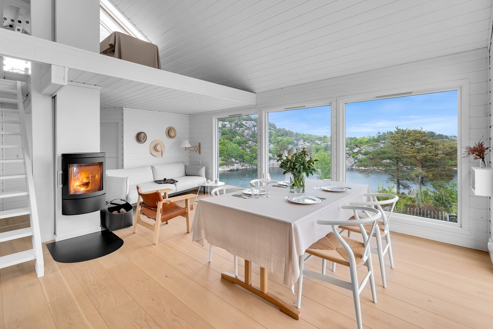 Hytten har nyere peisovn i senter av hytten og vindusflater med utsikt mot kystlandskap og Hillevågen. Galleribilde