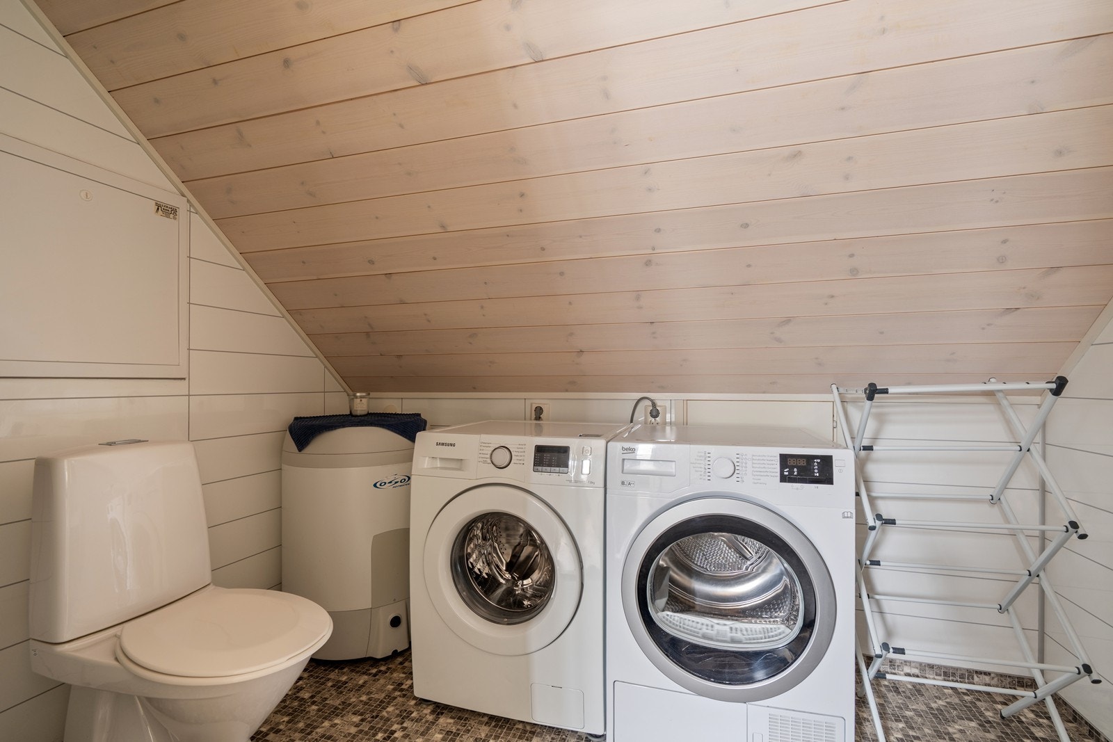 Badet har opplegg for vaskemaskin og plass til tørketrommel. Galleribilde
