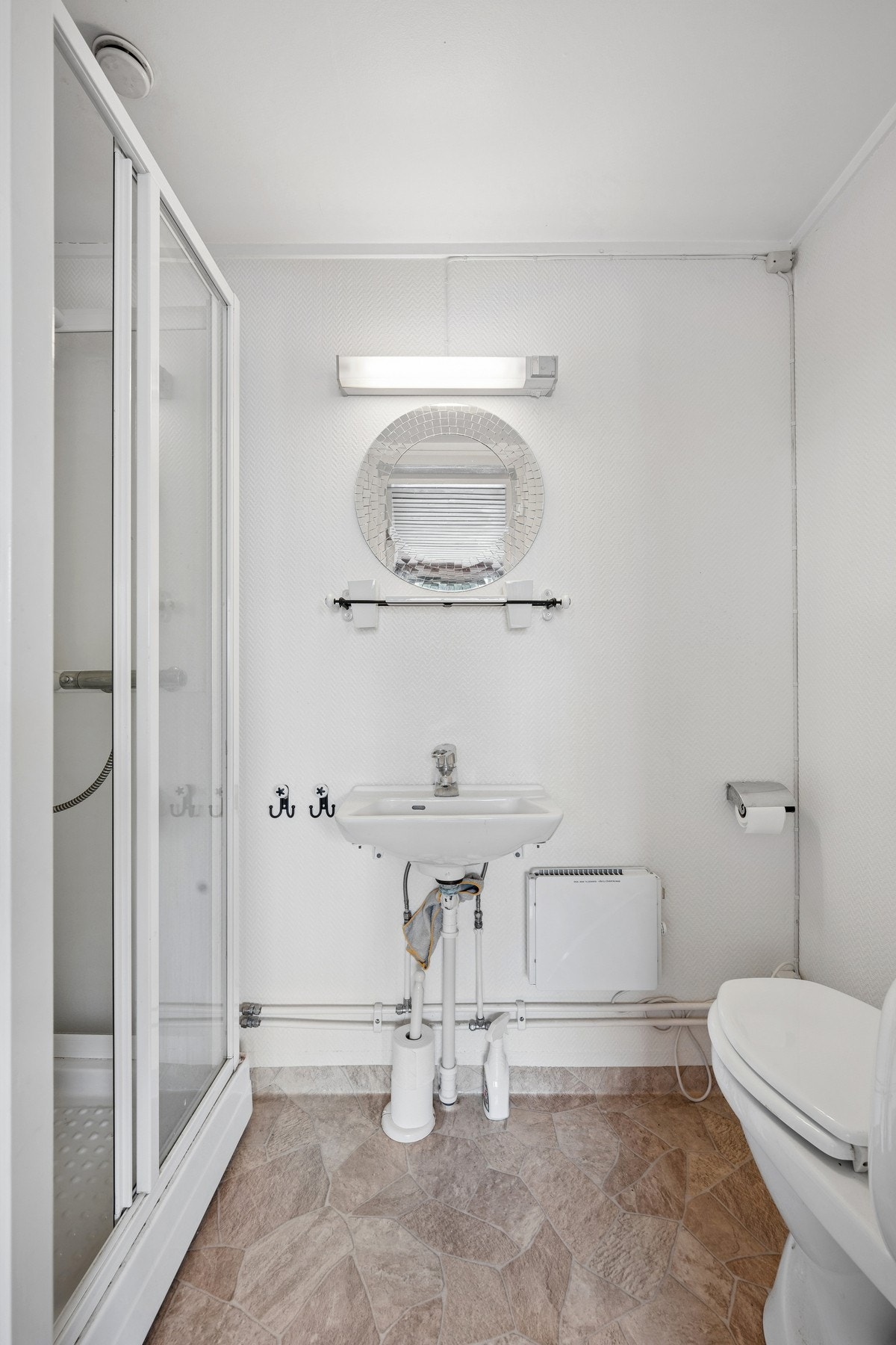 Badet i underetasjen har dusjkabinett og servant fra 2000. Galleribilde